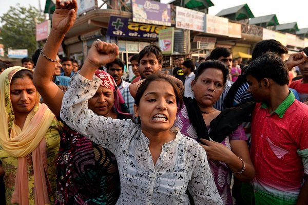 Indian protesters shout slogans during a demonstration near the home of a minor girl who was raped in New Delhi on October 17, 2015. A toddler and a five-year-old girl were raped in separate attacks in New Delhi overnight with at least one gang-raped, police said October 17, as activists warned of an "epidemic" of sexual violence in the capital. The two-and-a-half-year-old girl was abducted from a religious event in west Delhi by two men on the night of October 16 and raped before being dumped in a park near her home, relatives and police said. In a separate incident on the other side of the city, the five-year-old was lured to a neighbour's house and raped by three men, a police officer told AFP. AFP PHOTO / Chandan KHANNA / AFP / Chandan Khanna